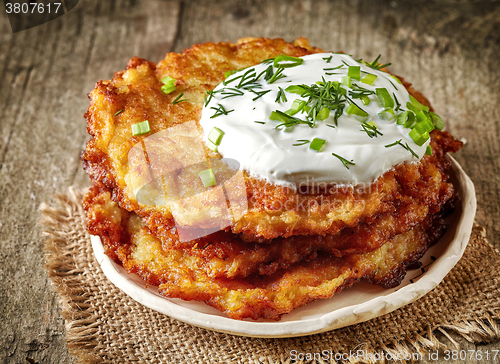 Image of Potato pancakes on wooden table