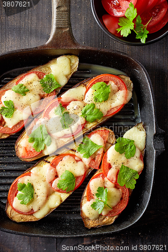 Image of Baked eggplant with tomatoes and cheese