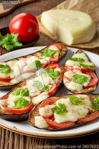 Image of Baked eggplant with tomatoes and cheese