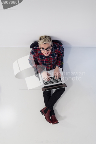 Image of top view of young business woman working on laptop computer