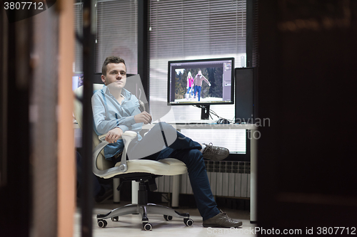 Image of photo editor at his desk