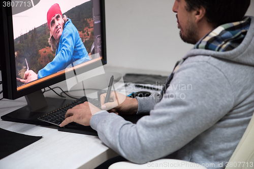 Image of photo editor at his desk