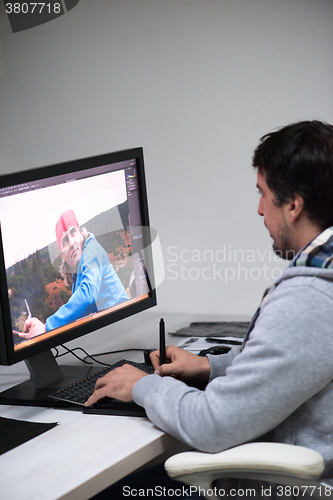 Image of photo editor at his desk