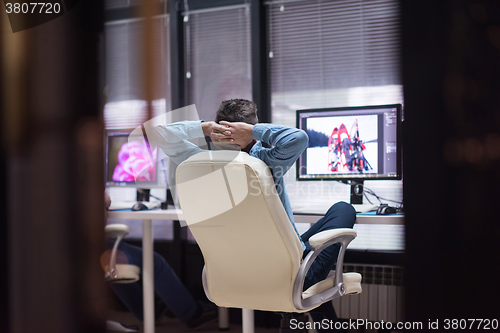 Image of photo editor at his desk