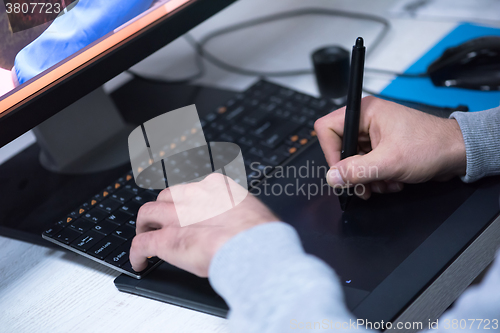 Image of photo editor at his desk