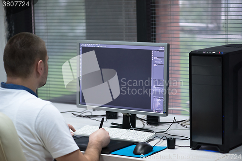 Image of photo editor at his desk