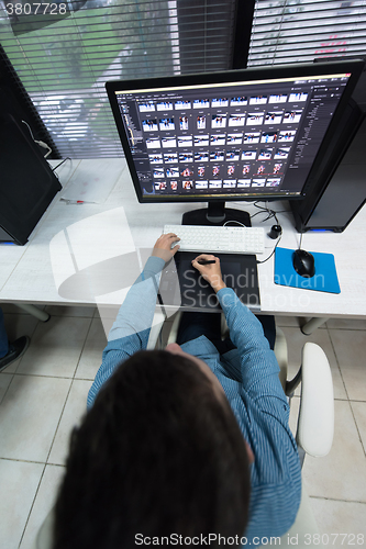 Image of photo editor at his desk