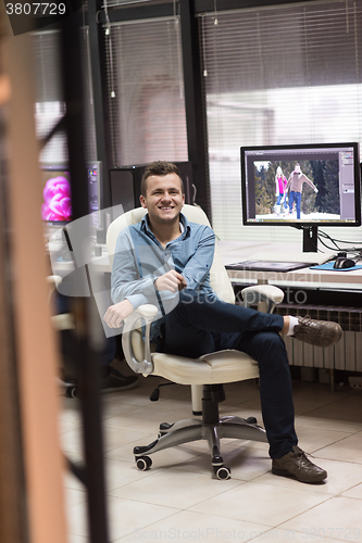 Image of photo editor at his desk