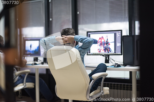 Image of photo editor at his desk