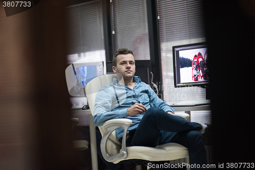 Image of photo editor at his desk