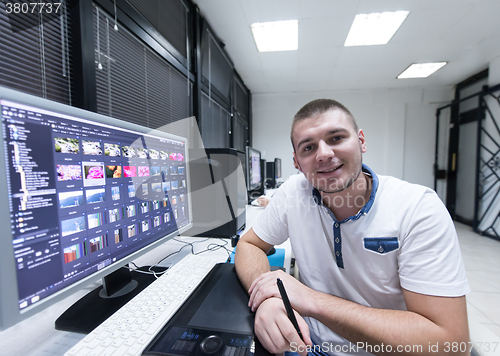 Image of photo editor at his desk