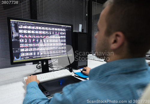 Image of photo editor at his desk