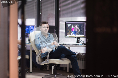 Image of photo editor at his desk