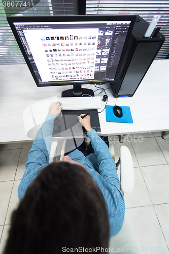 Image of photo editor at his desk