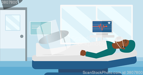 Image of Patient lying in hospital bed with heart monitor.