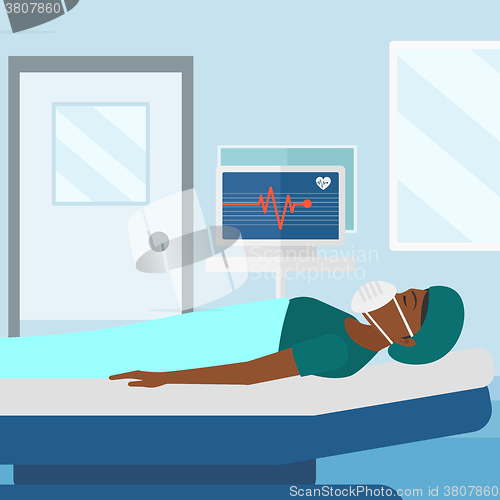 Image of Patient lying in hospital bed with heart monitor.