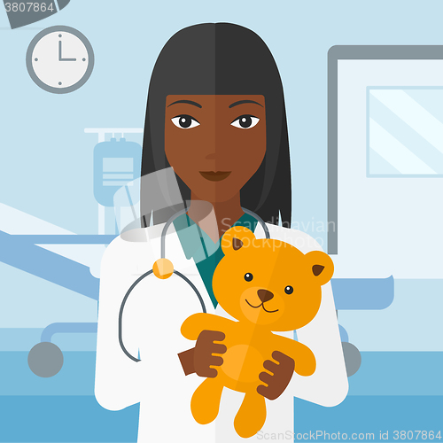 Image of Pediatrician holding teddy bear.