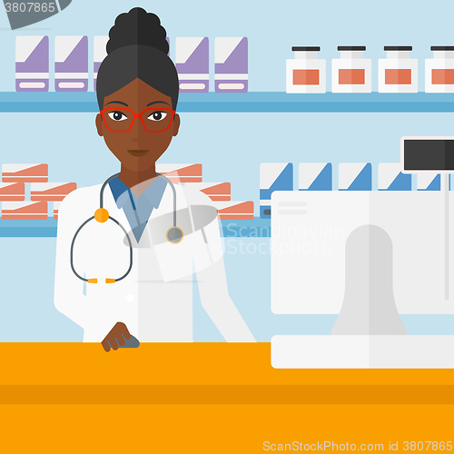 Image of Pharmacist at counter with computer monitor.