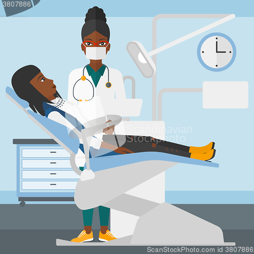 Image of Dentist and woman in dentist chair.