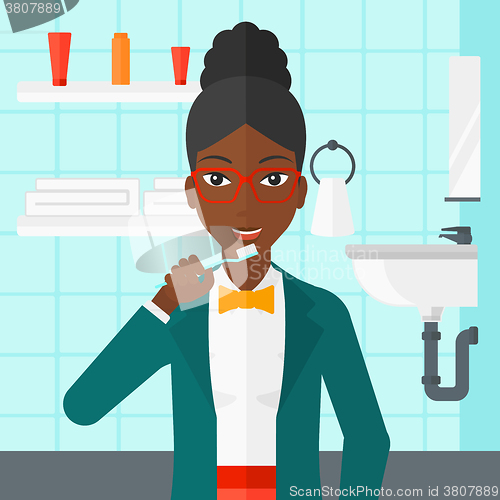 Image of Woman brushing teeth.