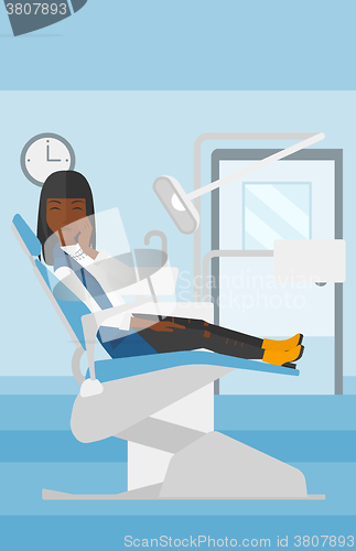 Image of Woman suffering in dental chair.