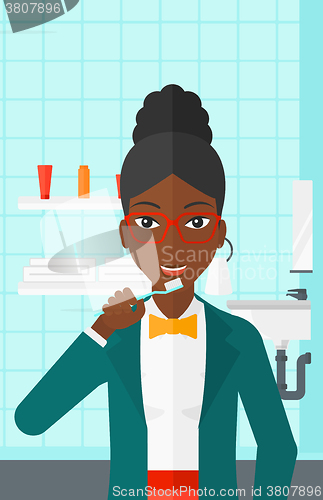 Image of Woman brushing teeth.