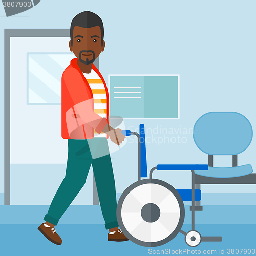 Image of Man pushing wheelchair.