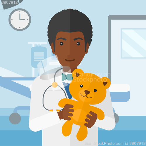 Image of Pediatrician holding teddy bear.