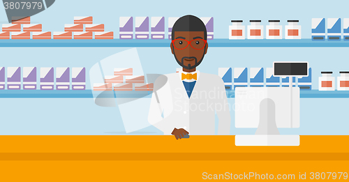 Image of Pharmacist at counter with computer monitor.