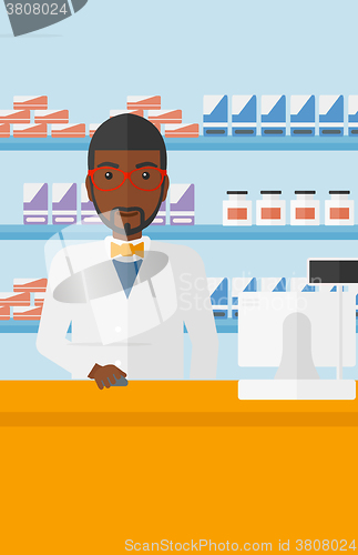 Image of Pharmacist at counter with computer monitor.