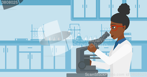 Image of Laboratory assistant with microscope.