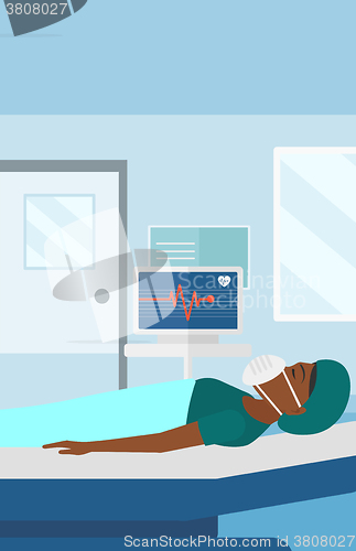 Image of Patient lying in hospital bed with heart monitor.