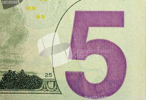 Image of five dollars,  close up.