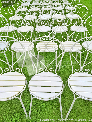 Image of White chairs on green grass