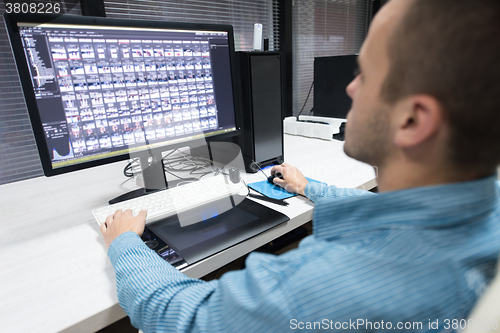 Image of photo editor at his desk