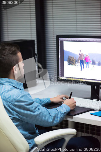 Image of photo editor at his desk