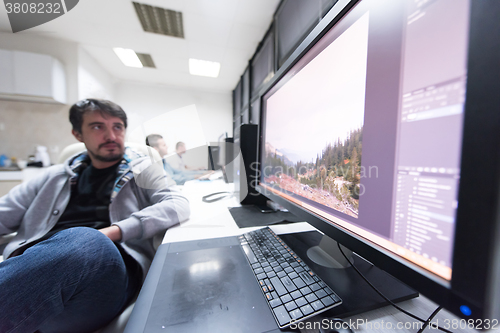 Image of photo editor at his desk