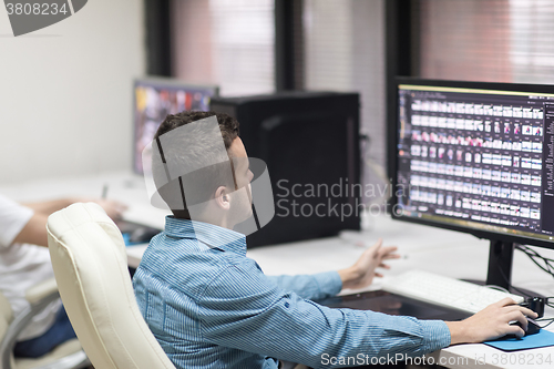 Image of photo editor at his desk