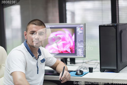 Image of photo editor at his desk