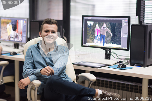 Image of photo editor at his desk