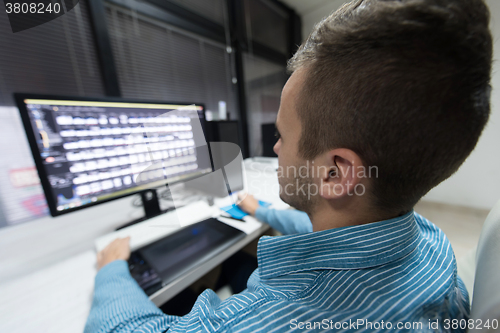 Image of photo editor at his desk