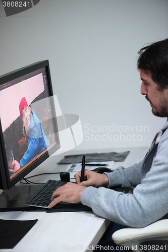 Image of photo editor at his desk