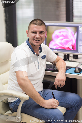 Image of photo editor at his desk