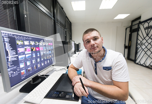 Image of photo editor at his desk