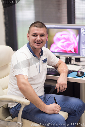 Image of photo editor at his desk