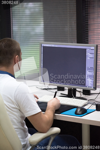 Image of photo editor at his desk