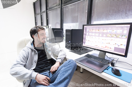 Image of photo editor at his desk