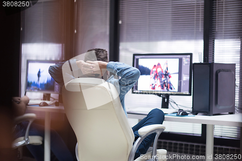 Image of photo editor at his desk