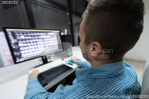 Image of photo editor at his desk