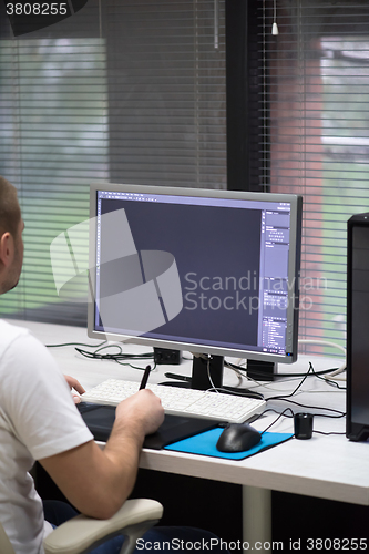 Image of photo editor at his desk